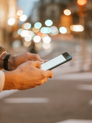 Close-up of male hands with smartphone outdoors