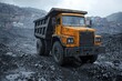 © Outkast - Yellow Dump Truck in a Coal Mining Site with Buildings in the Background
