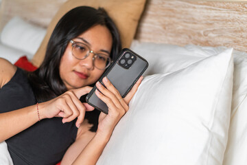 Person Using Smart phone in Bed