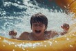 © Fotograf - A young boy having fun in an inflatable pool on a sunny day