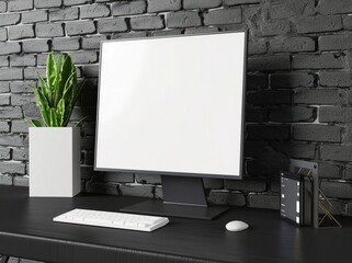 A modern computer monitor with a blank white screen sits on a dark desk with a white keyboard. mouse. and plant in a white pot The backdrop is a black brick wall