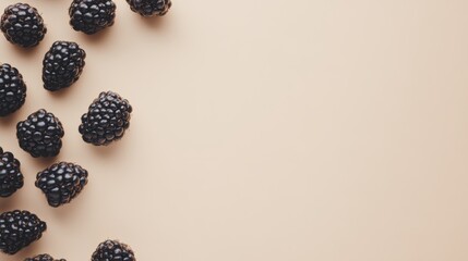 Wall Mural - Fresh blackberries arranged on a neutral background creating negative space