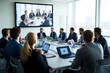 © Tondone - Business professionals in a modern conference room engage in a video call, discussing strategies and collaborating with technology assistance.