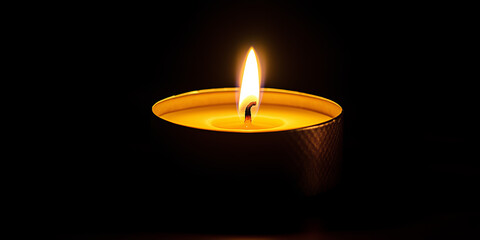 Single candle burning brightly in darkness against dark black background with copy space. Funeral and remembrance concept.