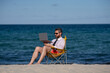 © Volodymyr - Crazy free businessman. Fun business lifestyle. Handsome excited business man with laptop in sea beach. Funny businessman. Freelance concept, summer business. Business success.