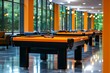 © Thanyarat - A vibrant community room with pool tables, gaming consoles, and residents enjoying games and conversations, capturing the social and recreational amenities offered in modern living spaces, symbolizing