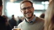 © liliyabatyrova - A man with glasses is smiling and holding a glass of beer