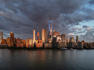 New York City. NYC aerial view, New York City Skyline with dramatic sky. Panoramic drone view on Manhattan in NY. Sunset in NYC. New York City Midtown skyline view at dusk with dark clouds.