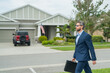 © Volodymyr - Businessman walk near house in american neighborhood. Business man walk down street, late for a meeting. Business man in suit walking be success. Walking business man.