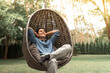 © kieferpix - Happy smiling young man relaxing in home garden enjoying nature weekend time off