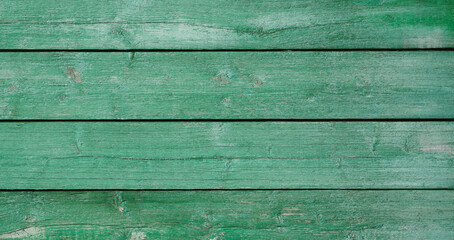Aufkleber - A green wooden background with a few brown spots. The wood grain is visible and the background is mostly green