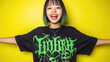 © Konstiantyn Zapylaie - Joyful teen with trendy green hair in graphic tee against vibrant yellow background
