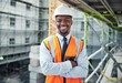 © peopleimages.com - Happy, portrait and black man with confidence for construction site, architecture or civil engineering. Young African, male person or contractor with smile or arms crossed for industrial development