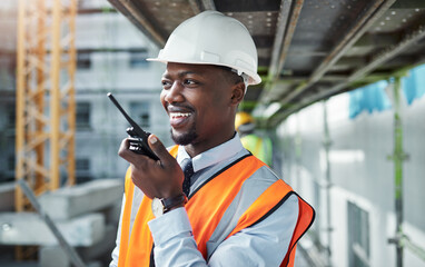 Black man, architect and talking with radio at construction site for communication on infrastructure. Young African, civil engineer or builder with speaker, voice message or signal in an urban city