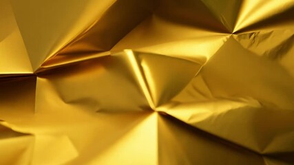 Leinwandbilder - A surface of crumpled golden foil displays dramatic folds and reflections, creating a captivating interplay of light and texture that catches the eye.