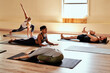 © peopleimages.com - Stretching, yoga and fitness with people in class for holistic health, flexibility and workout. Pilates, exercise and healing with group of friends in studio for breathing, zen and wellness balance