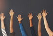 © peopleimages.com - Raise your hand if youre part of our team. Shot of a group unrecognizable people holding up their hands inside of a building.