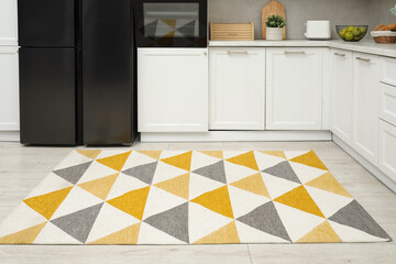 Canvas Print - Stylish soft rug on wooden floor in kitchen