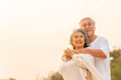 © CandyRetriever  - Happy Asian family senior couple enjoy outdoor lifestyle travel nature at the sea on summer beach holiday vacation. Healthy elderly husband and wife relaxing romance hug on tropical island at sunset.