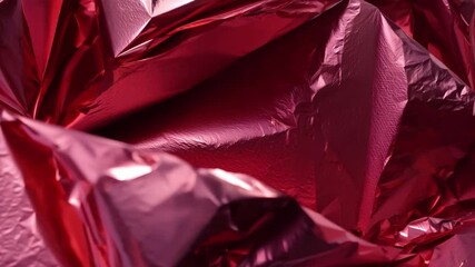 Poster - The surface features a vibrant red foil that creates an abstract texture, showcasing dynamic folds and glossy reflections in varied light, perfect for creative projects.