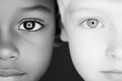 © Hew Pallot - black and white portrait of african and caucasian children's faces side by side