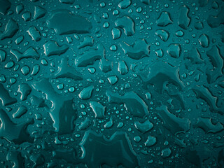 Water droplets on a blue surface