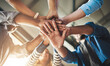 © Donson/peopleimages.com - Hands, group and business people in low angle at office for support, motivation or diversity with link. Stack, men and women for teamwork, synergy or happy with celebration for job at creative agency