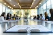 © Chin - Point of view of chief executive officer in conference presentation, Meeting table with colleague and presentation information paper, Committed employee discussion in office.