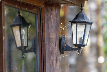 Wall Mural - A black lamp is lit up and is reflected in a window