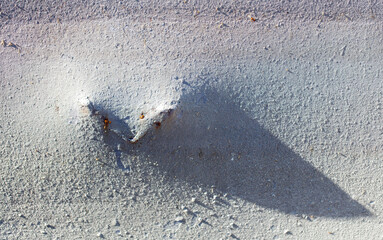 Wall Mural - A shadow of a heart is cast on a grey surface