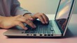 © Kraitong - Hands Typing on Laptop Keyboard