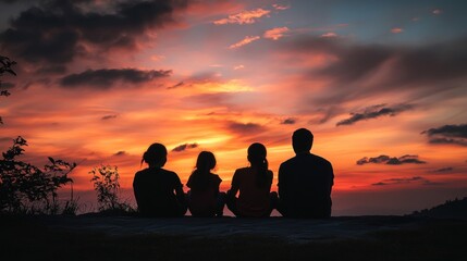 Wall Mural - A group of four people sitting together, enjoying a sunset view.