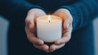 © thanakrit - Hands Holding a Candle with Soft Lighting