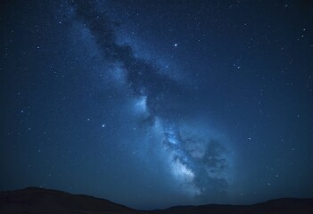 A night sky filled with countless stars against a deep blue-black background