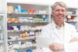 © peopleimages.com - Man, happy and portrait of pharmacist with prescription at dispensary for medication, supplements or pills. Chemist, inventory and senior male apothecary with stock list for medicine in drug store.