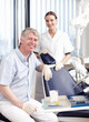 © peopleimages.com - Portrait, man and dentist with assistant at clinic for dental healthcare, professional advice and mouth cleaning. Smile, people and teamwork with medical career, teeth treatment and hygiene checkup