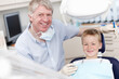 © peopleimages.com - Portrait, child and checkup with dentist at clinic for appointment, teeth whitening and dental hygiene. Happy, man and patient with mouth cleaning, braces treatment and medical advice for childhood