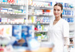 © peopleimages.com - Pharmacist, happy and pills in stock, portrait for medicine in drugstore, chemist or services. Medical professional, female person and pharma in clinic for prescription, dispensary for info or advice