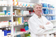 © peopleimages.com - Man, pharmacist and happy with arms crossed on portrait for medication, prescription and service in Germany. Mature person, shop manager and employee with confidence, smile and pride at pharmacy