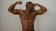 © Krakenimages.com - Young black man flexes muscular biceps over isolated white background showcasing strength and fitness