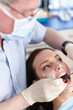 © peopleimages.com - Dentist, mirror tool and woman with teeth cleaning, medical check and patient consultation for oral care. Wellness, consulting and hospital for dental hygiene, assessment and mouth examination