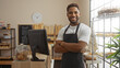 © Krakenimages.com - Young man smiling in a bakery with arms crossed in front of counter and shelves of bread and pastries