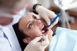 © peopleimages.com - Dentist, healthcare and woman closeup with teeth cleaning, medical check and patient consultation for oral care. Wellness, consulting and hospital for dental hygiene, assessment and examination tools