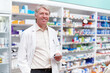 © peopleimages.com - Man, portrait and pharmacist with prescription at dispensary for medication, supplements or pills. Chemist, inventory and mature male apothecary with stock list for medicine or tablets in drug store.
