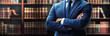 © KumCup - confident man in blue suit stands with arms crossed in front of library filled with books, exuding professionalism and authority