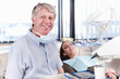 © peopleimages.com - Happy, patient and portrait of dentist for consulting, teeth whitening and oral health in clinic. Healthcare, dentistry and man with woman with tools for dental hygiene, cleaning and medical service