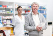 © peopleimages.com - Portrait, pharmacist and senior man with medicine, package and healthcare with prescription. Face, people and mature customer with professional, medical and drug store for pills, parcel and service