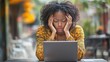 © Gia - Frustrated Woman Working on Laptop in Outdoor Café