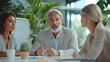 © Raphael - Réunion d'équipe diversifiée dans un bureau moderne, collaboration intergénérationnelle