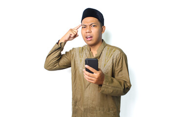 confused asian muslim man holding mobile phone with touching his head isolated on white background